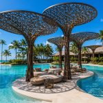 Contemporary sculptural shade structure overlooking a beachfront resort.