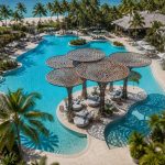 Contemporary sculptural shade structure overlooking a beachfront resort.